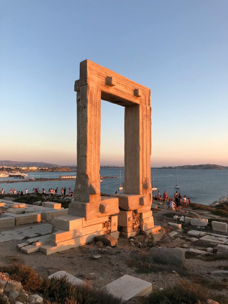 The Portara marble gate of the ancient Temple of Apollo in Naxos, Greece, glowing under the sunset sky – one of the best Greek island landmarks to visit in 2025